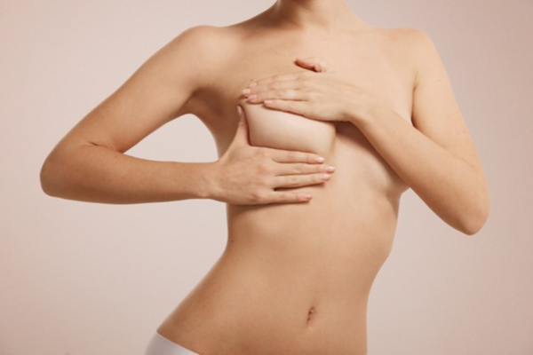 Everything We Know of Breast Implant Cancer Blog on Coco Ruby Plastic Surgery - Woman Holding Her Breast with Two Hands